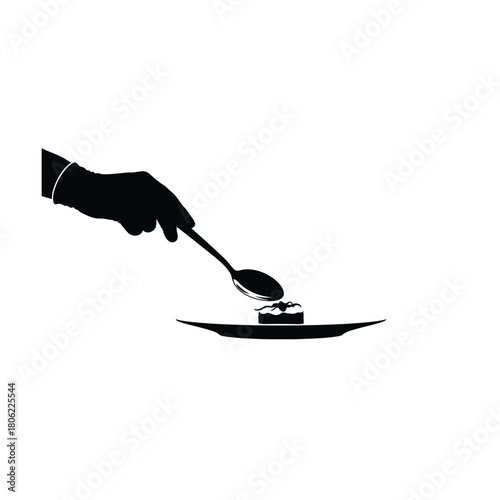 Chef s hand carefully places delicate food item onto plate with spoon