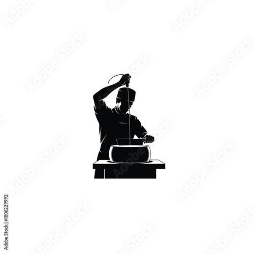 Silhouette of a craftsman shaping clay on a pottery wheel with focused intensity