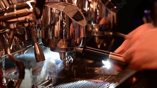 Professional espresso machine pouring hot coffee into glasses