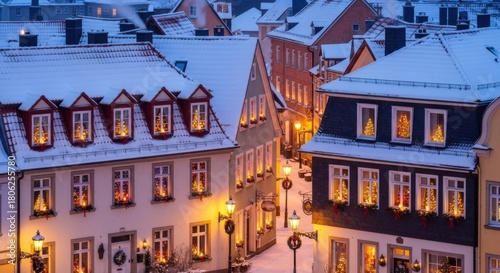 Magical winter wonderland scene with snow covered rooftops and warm lights glowing from Christmas trees in windows creating cozy holiday atmosphere