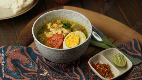 Soto ayam or chicken soto, Indonesian food on the table with sambal.