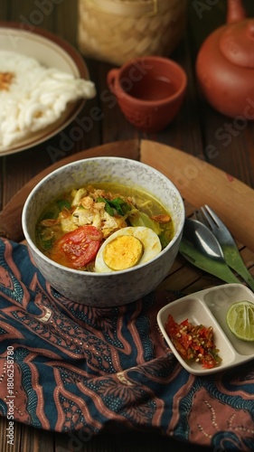 soto ayam or chicken soto, Indonesian food on the table with sambal. 