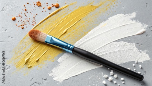 Makeup brush with colorful swatches of foundation and blush