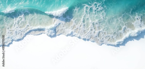 Aerial photo of ocean waves crashing onto a white beach. Turquoise water creates a beautiful pattern. Natural beach texture with foam and water edge. Peaceful summer seaside view.