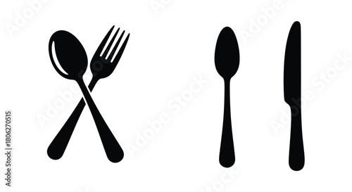 Black silhouettes of a spoon fork and knife set on white background