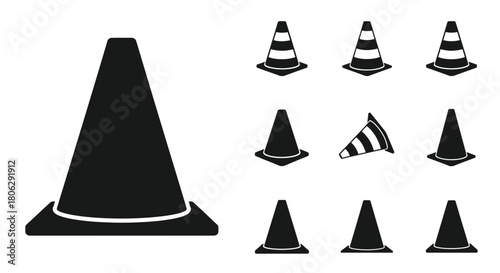 A collection of black and white traffic cones in various orientations