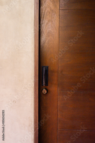 Closeup of wooden door with classic golden handles and ornaments,gold door handle and lock,Beautiful entrance to an expensive home or Luxury hotel,Copy space.