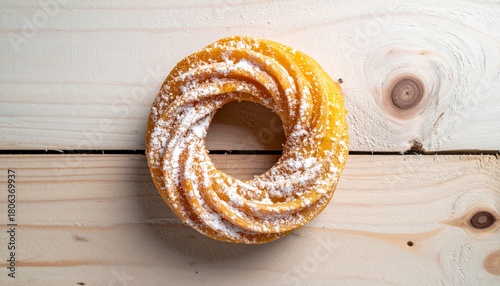 Top View of Sugared Cruller Donut Ring on Light Wooden Surface