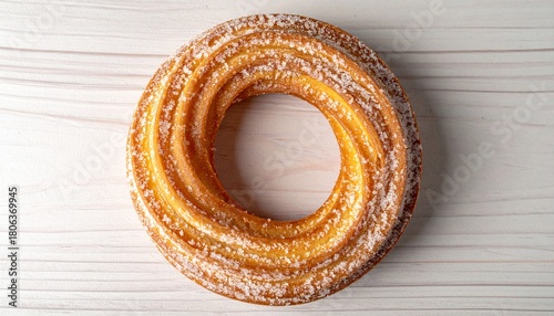 Top View of Sugared Cruller Donut Ring on Light Wooden Surface