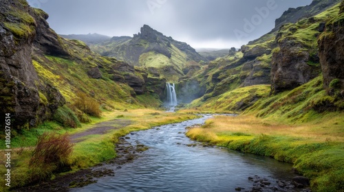 Majestic waterfall cascading into a winding river through a mossy, green canyon. Nature landscape for travel and adventure inspiration.
