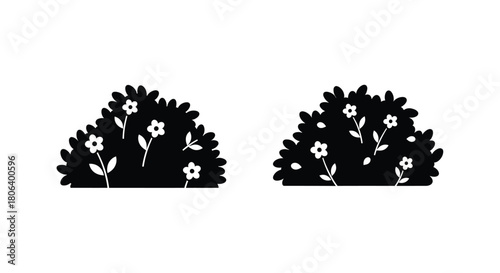 Two simple black silhouettes of flowering bushes on a white background