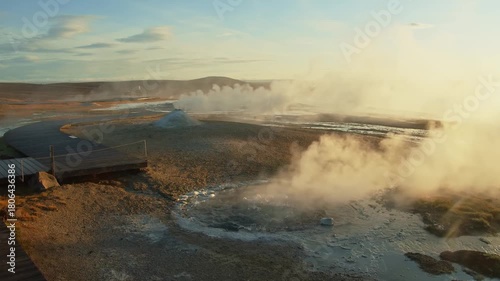 A powerful eruption of the Strokkur geyser in the Haukadalur Valley, Iceland. The footage captures the dramatic moment the geyser shoots a column of hot water and steam high into the air against a bac