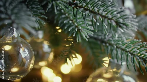 Close up of Christmas tree ornaments and lights with bokeh effect.
