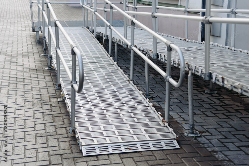Obraz premium ramp on stairs for baby strollers, bicycles and wheelchairs, accessible urban environment