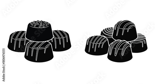 A collection of dark chocolate truffles with decorative white chocolate swirls