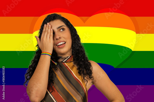 Woman celebrating lgbtq+ pride with a rainbow flag background