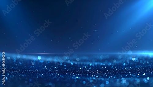 Abstract blue background featuring sparkling particles and soft lighting effects