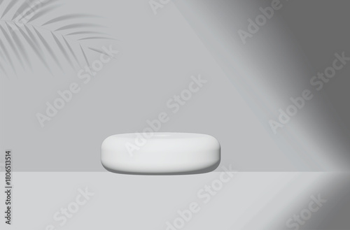 
the minimal room have a round seat in the middle of the grey room with light and shawdows,the coconut leaf shadow falling the grey wall,is peaceful