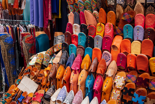 Colorful collection of handcrafted footwear displayed in a vibrant market setting, showcasing intricate designs and textures, perfect for fashion enthusiasts and cultural exploration