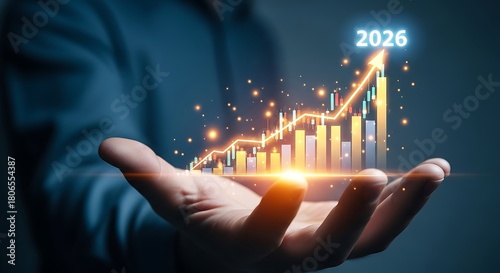 Hand holding glowing financial growth chart with year 2026