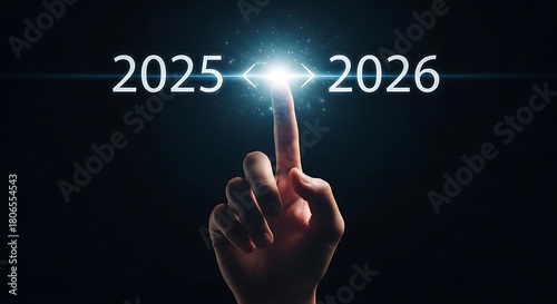 Finger points to the future from 2025 to 2026 with bright light