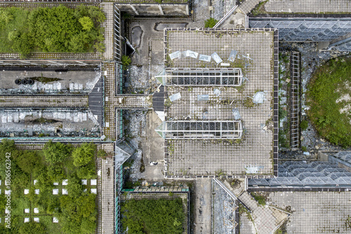 Aerial view of the decaying urban landscape, where concrete structures meet patches of vibrant greenery, creating a stark contrast between nature and abandonment, Zagreb, Croatia.