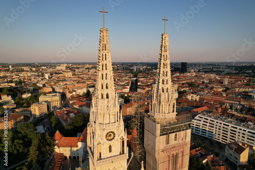 Wallpaper Mural Aerial view of the majestic Zagreb Cathedral spires reaching towards the sky, casting long shadows over the cityscape, Zagreb, Croatia. Torontodigital.ca