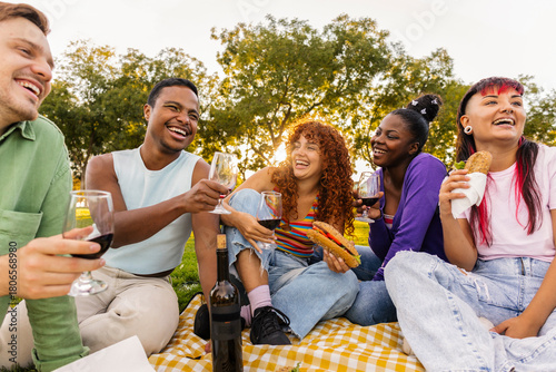 Photography Diverse happy friends having picnic drinking wine outdoors