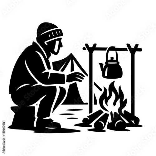 camper sitting by a fire with a kettle hanging over flames