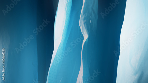 Blurred background of blue canvas with sunlight. Abstract texture background with dark and light from sunshine. Blurry plastic texture, material, artistic for wallpaper, poster, print, background.