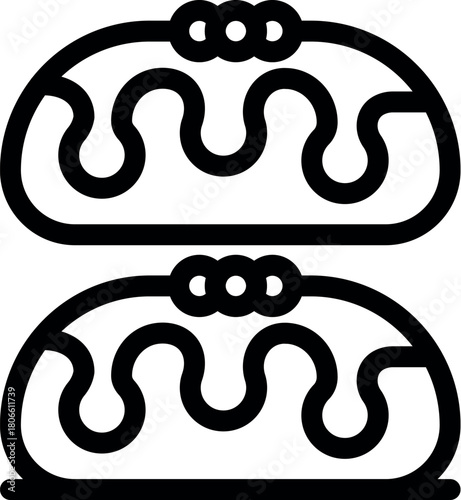 Two identical eclairs with chocolate icing and three chocolate chips representing french pastry dessert