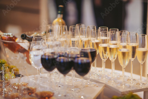 Sparkling and red wines served at a festive gathering with elegantly arranged glasses in a social setting