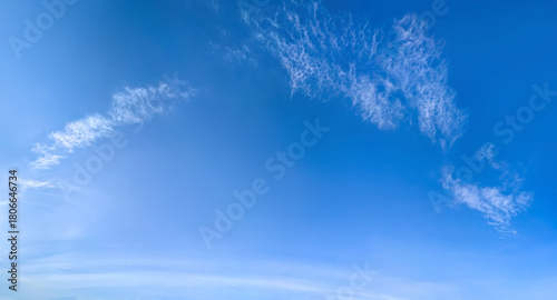 A large white cirrus clouds on a blue background. Detailed steam with cottony ends. Harsh midday chiaroscuro. Imaginary forms of psychological observation.