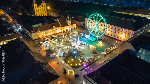 Aerial view of a festive square with a brightly lit Ferris wheel and baroque buildings creating a magical spectacle, Osijek, Osijek-Baranja County, Croatia.