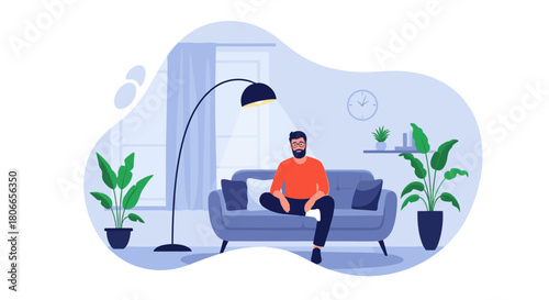 Young bearded man with glasses relaxes on a comfortable sofa in his modern and stylish living room with indoor plants.
