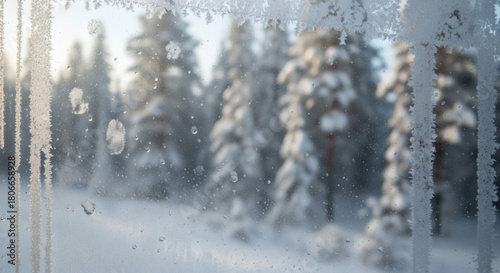 Close-Up of Frosted Train Window With Condensation, Fingerprints and Soft Motion Blur of Snowy Forests During a Winter Journey