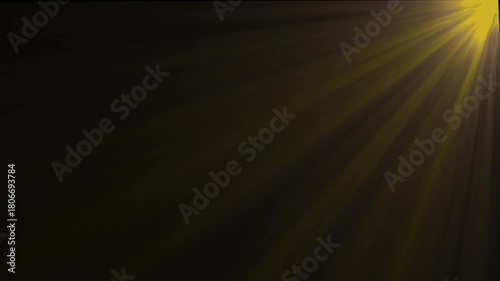 Golden sunbeams radiating from top right corner across dark background ethereal light rays