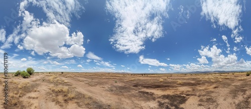 Panoramic view of vast arid landscape with striking cloudscape