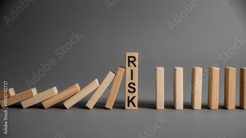 Wooden blocks demonstrate the concept of mitigating potential hazards with one piece standing firm