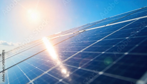 Solar Panel Efficiency A close up, angled shot of multiple high efficiency solar panels gleaming under bright sunlight. The textured surface of the panels reflects the clear blue sky and wispy clouds.