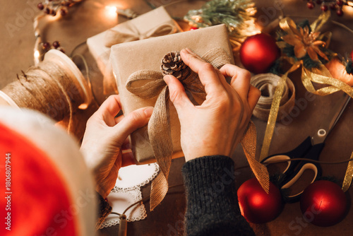 Top view of woman hands preparing christmas gift