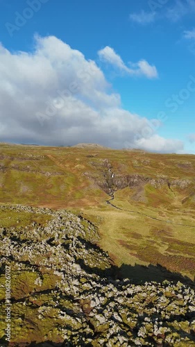 Aerial view of a waterfall on the Snaefellsnes peninsula in Iceland - vertical 4K video