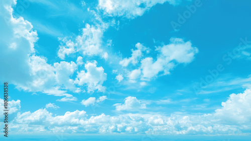 Vibrant blue sky with fluffy white clouds, serene natural background texture