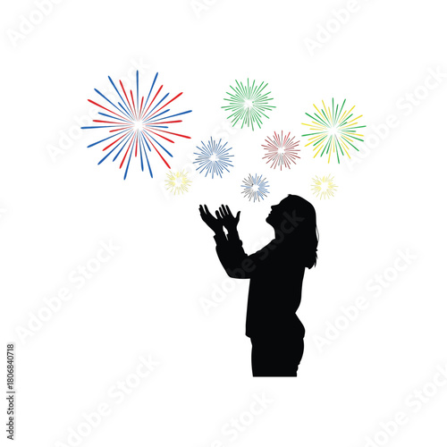 Silhouette of a person looking up at colorful fireworks