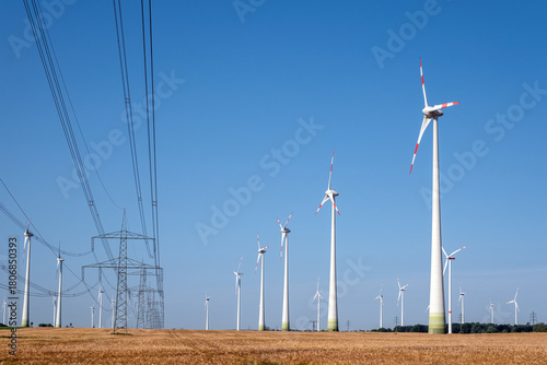 Electricity pylons with power lines and wind energy plants seen in Germany