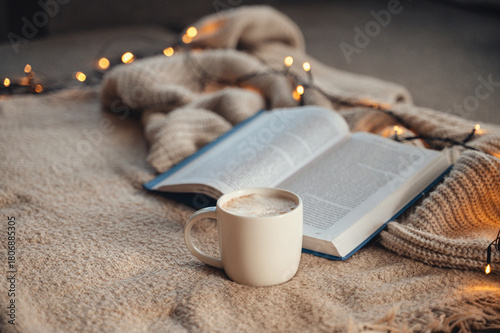 Cozy Christmas morning with warm blanket, cup of cocoa, and book