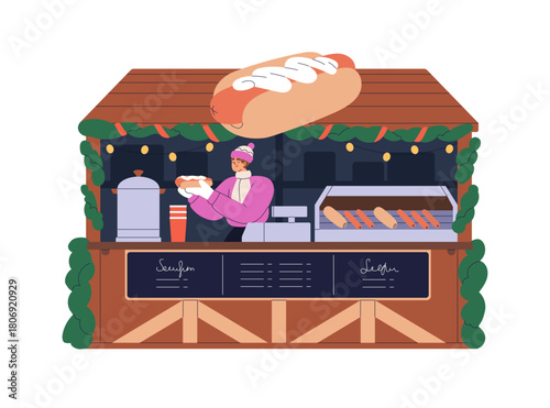 Winter holiday stall with street fast food. Vendor selling hotdogs at Christm...