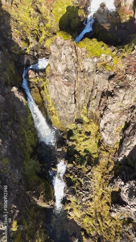 Aerial view of a waterfall on the Snaefellsnes peninsula in Iceland - vertical 4K video