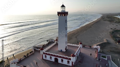 Drone footage of Faro Monumental lighthouse on the beach in La Serena, Chile