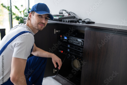 Audio engineer setting up speakers in office